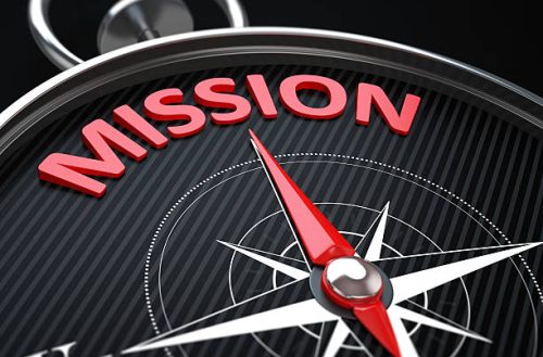 3d render image.  Compass needle pointing the green word mission.